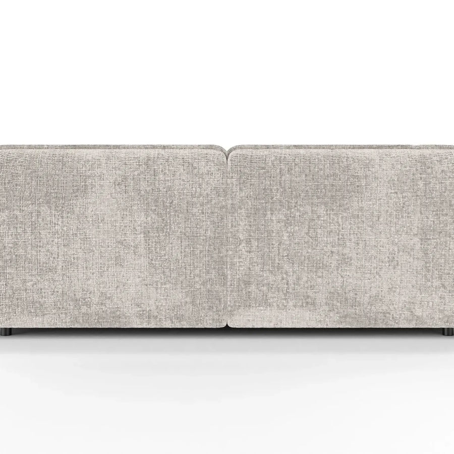 Canapé Mona droit en tissu beige clair vu de côté, accoudoirs arrondis visibles.