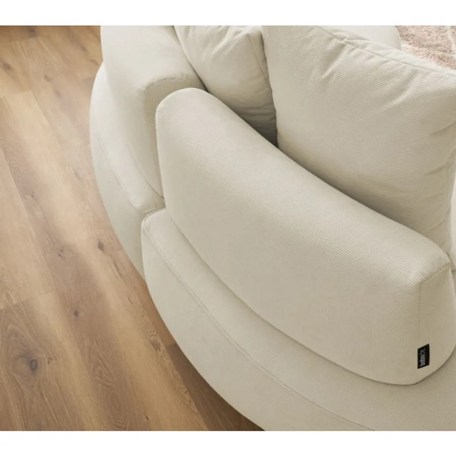 Détail du coussin et de l'accoudoir du canapé Saint-Germain blanc cassé avec étiquette.