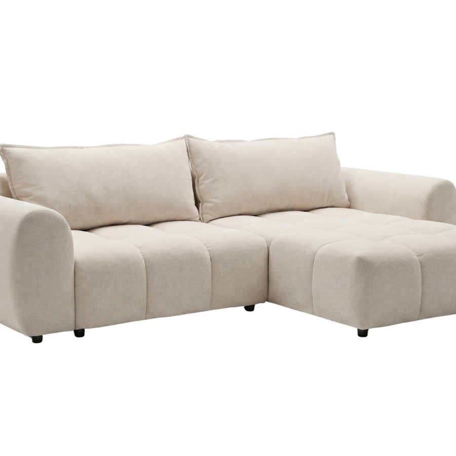 Canapé Viana d'angle en tissu crème détouré, vu de face, méridienne à droite et coussin pivotant.